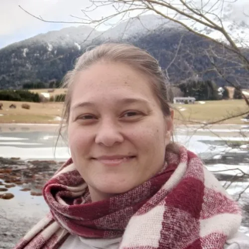 Ana Colautti's closeup picture, with the Austrian Alps in winter in the background